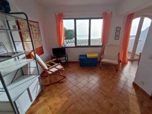 a living room with a view of the ocean at Apartament Bouganville in Alaior +14 photos