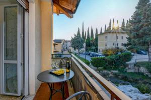a balcony with a table and a view of a street at Liver 201 in Tremosine Sul Garda