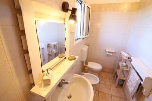 a bathroom with a sink and a toilet and a mirror at Bungalow Fragola in Otranto +22 photos