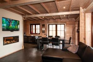 a living room with a table and a fireplace at Houten Villa Dirk in Den Ham