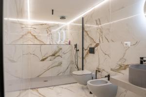 a bathroom with a toilet and a sink at Villa Coral Bay in Alghero +37 photos