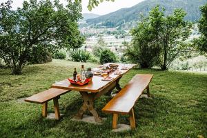 a picnic table with bottles of alcohol on top of a field at Schlossberghof Schnellingen in Haslach im Kinzigtal