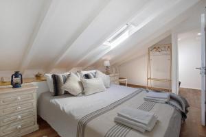 a bedroom with a large white bed and a dresser at Casa Holi in Valada +23 photos