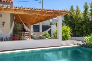 a swimming pool in a backyard with a pergola at Casa Holi in Valada