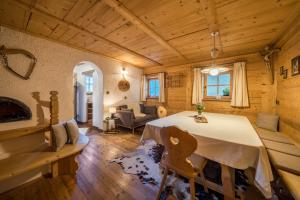 a dining room with a table and a couch at Thaler-hof Ferienhaus Lärchnhittl in Lagundo