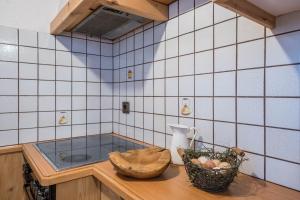 a kitchen with blue and white tiled walls at Thaler-hof Ferienhaus Lärchnhittl in Lagundo +31 photos