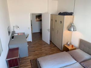 a small living room with a couch and a cabinet at Bodenseeloft H E 66 in Kressbronn am Bodensee +15 photos