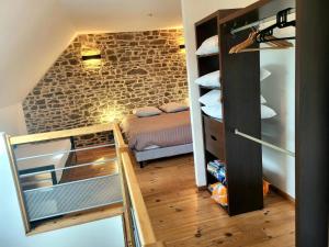 a small room with a bed and a closet at Petit Loft, Maison Bord De Mer in Pirou