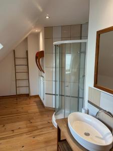 a bathroom with a sink and a glass shower at Petit Loft, Maison Bord De Mer in Pirou +14 photos