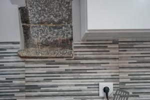 a room with a tile floor and a wall with a parking meter at Oásis Fonte Grande in Santo António +37 photos