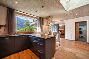 a kitchen with a counter and a large window at Chalet Riad 2 in Saltusio