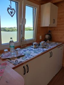 a kitchen with a counter top and two windows at Mobile Tinyhouse 2 by Wolfsberger in Mayrhof