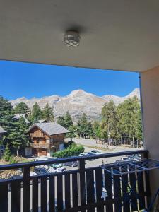 a room with a balcony with a view of a mountain at Studio Les Fontettes 2 in Le Dévoluy