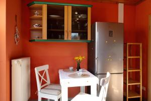 a small kitchen with a table and a refrigerator at Süd-Balkon an der schönen Peene in Demmin