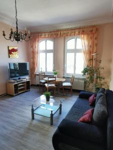 a living room with a couch and a table at Villa Adler- Seeseite in Ahlbeck +9 photos