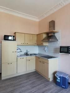 an empty kitchen with a sink and a refrigerator at Villa Adler- Seeseite in Ahlbeck