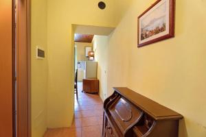 a hallway with a table and a picture on the wall at Quadrifoglio House in Ameno