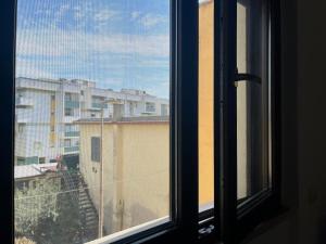 a window with a view of a building at La casetta di Claudia in Nettuno