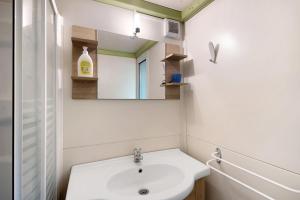 a bathroom with a sink and a mirror at chalet nel bosco in Casarza Ligure