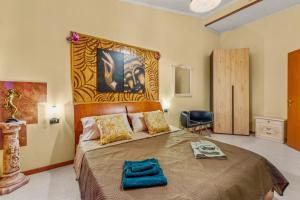 a bedroom with a large bed with a large headboard at Villa Angela in Quartu SantʼElena +22 photos