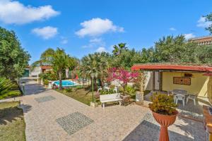 a villa with a swimming pool and a resort at Villa Angela in Quartu SantʼElena