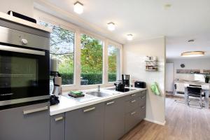 a kitchen with a sink and a large window at Ferienwohnung im Eichholz in Arnsberg
