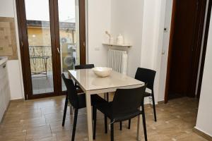 a dining room table with chairs and a bowl on it at La casetta di Claudia in Nettuno +20 photos