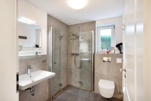 a bathroom with a shower and a sink and a toilet at Ferienwohnung im Eichholz in Arnsberg +11 photos