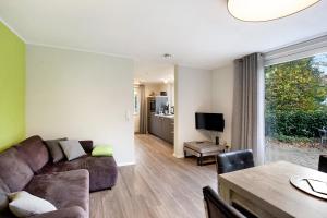 a living room with a couch and a table at Ferienwohnung im Eichholz in Arnsberg