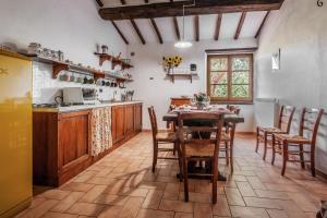 a kitchen with a table and chairs in a room at Girasole in Arcidosso