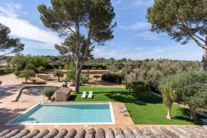 an image of a garden with a swimming pool at Can Luciana in La Aranjasa
