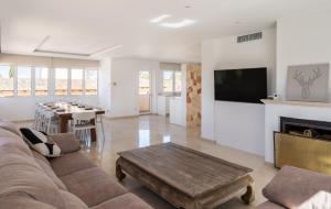 a living room with a couch and a fireplace at Can Luciana in La Aranjasa