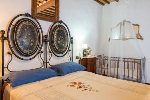 a bedroom with a large bed and a crib at Beb 1416 in Anghiari