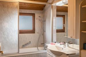 a bathroom with a shower and a sink and a tub at Familienwohnung Haus 18 in Überlingen +16 photos