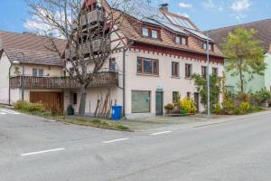 a large white house with a balcony on a street at Familienwohnung Haus 18 in Überlingen