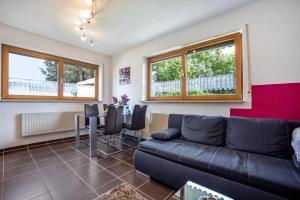 a living room with a couch and a table at Ferienwohnung-4you in Sigmarszell +14 photos