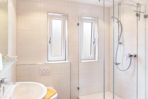 a bathroom with a shower and a sink at Ferienwohnung - Hexi in Bad Kohlgrub +12 photos