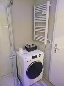 a washing machine with a box on top of it at Wohnung in Elz in Elz