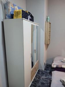 a white cabinet in a room with a mirror at Wohnung in Elz in Elz