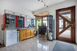 a kitchen with a refrigerator and a sliding door at Ferienwohnung-4you in Sigmarszell