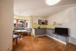 a kitchen with a table and a dining room at Stompferhof Erkerwohnung in Caldaro