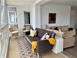 a living room with a couch and a table at Piso en el Mar in Salinas +27 photos