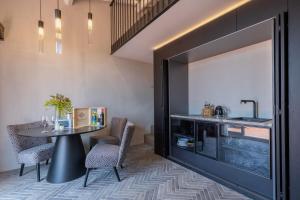 a kitchen with a table and a sink at Suite Limonaia in San Gimignano