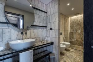 a bathroom with a sink and a mirror at Suite Limonaia in San Gimignano +15 photos