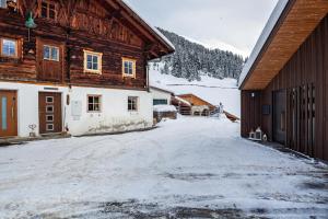 a snow covered yard in front of a building at Liberty Ranch Marlstein in Oetz