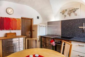 a kitchen with a table and a counter top at Liberty Ranch Marlstein in Oetz +18 photos