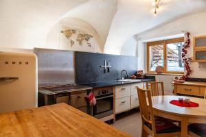 a kitchen with a table and a stove top oven at Liberty Ranch Marlstein in Oetz
