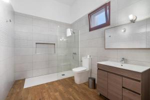 a bathroom with a toilet and a sink at Vv El Mirador in El Palmital +27 photos