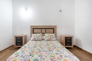 a bedroom with a bed with two night stands at Vv El Mirador in El Palmital