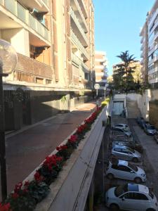 a row of cars parked on a street next to buildings at Morra's Home in Naples